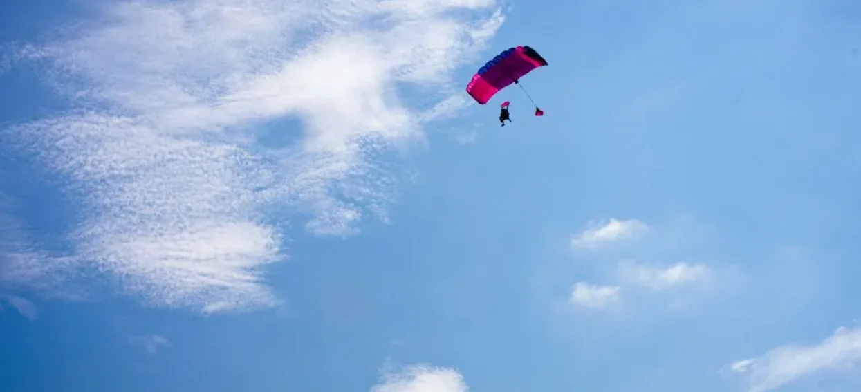 Skydiving instructor plummets to death, student dangles in tree