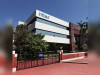 Infosys reports Q1 profit dip, revises FY26 revenue growth forecast upward.webp