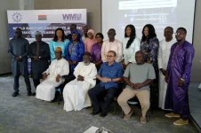 Gambia's WMU alumni get together to talk about boats.webp