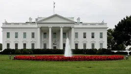 Trump watches as Kai pawns White House shirt.webp