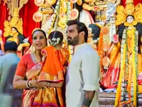 Bipasha shields her daughter Devi from the pandal chaos.webp