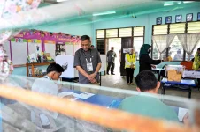 Sabah voters shrug off rain, polls heat up despite dip.webp