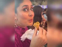 Caught snacking, Kareena Kapoor Khan eats a samosa at a school event.webp