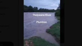 Family of five stranded in rising river, begging for rescue.webp