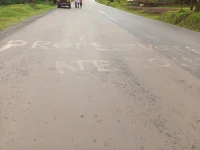 “Protest Vote” scrawled on highway, police hunt NUP-linked suspects.webp