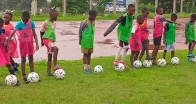 Kids chase dreams through rain, boots on the reward list.webp