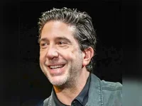 Schwimmer steps out, hand in hand with new flame.webp