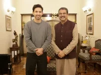 Vikrant Massey trades notes with the education minister after a big win.webp