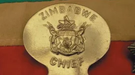 Chief Gutu demands an illegal ten-dollar tax from village heads.webp